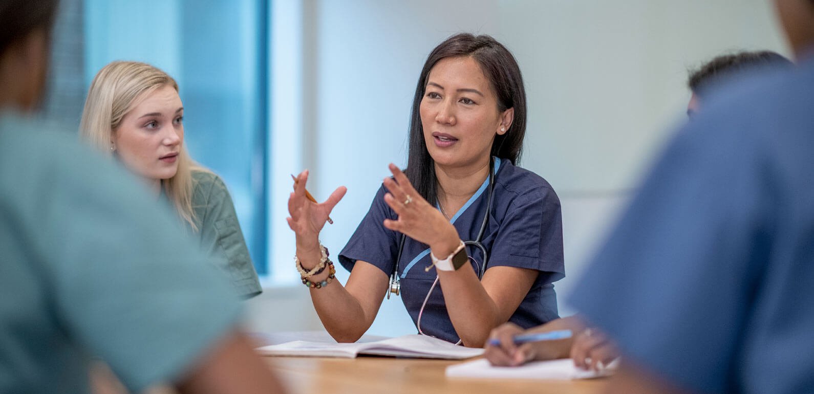 Group of health workers discussing around the table