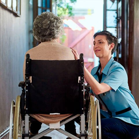 Health worker helping elderly lady