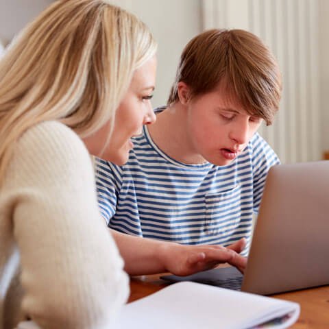 Support work helping young person with a computer