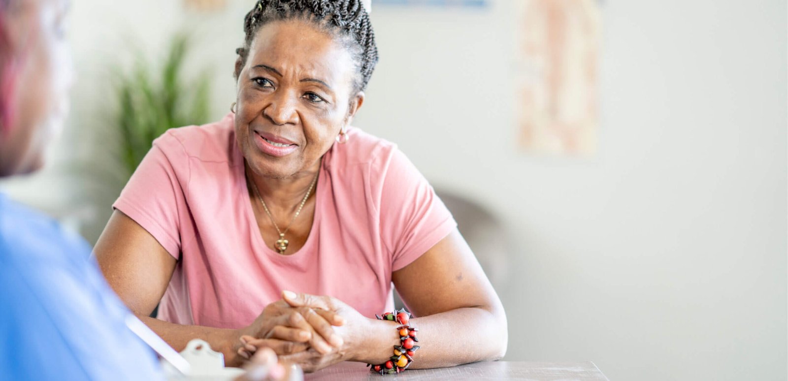 Woman talking to a health care worker at a table